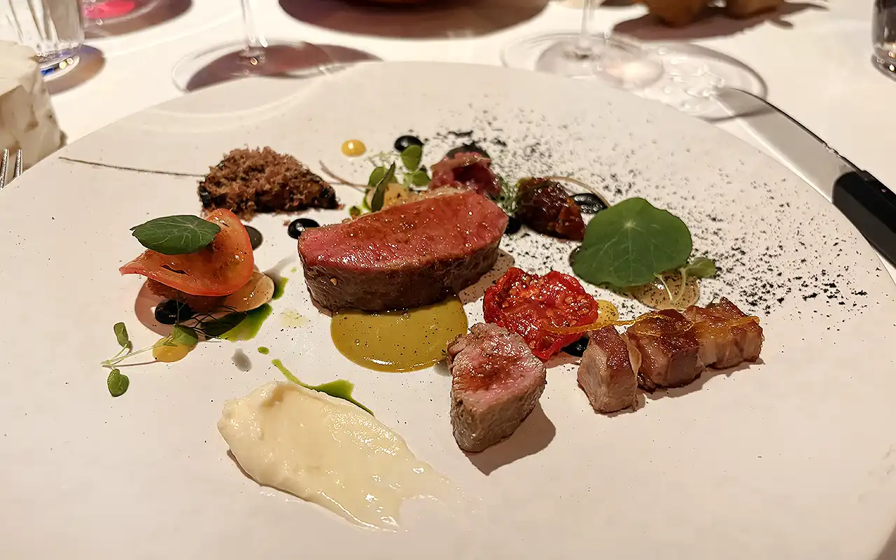 Lamb dish with Amela tomato, pistachio, yuzu, and black sesame amazake, served at The Ledbury