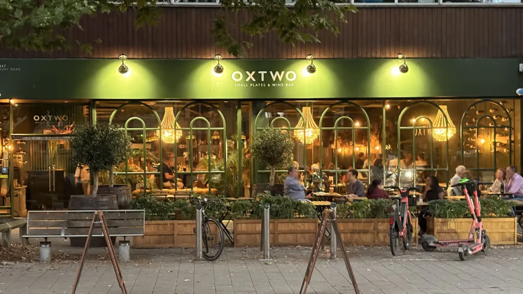 Exterior of restaurant Oxtwo in Oxford with outdoor seating and warm interior lighting