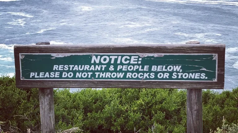 Sign in Hermanus, South Africa: “Restaurant & people below, please do not throw rocks or stones
