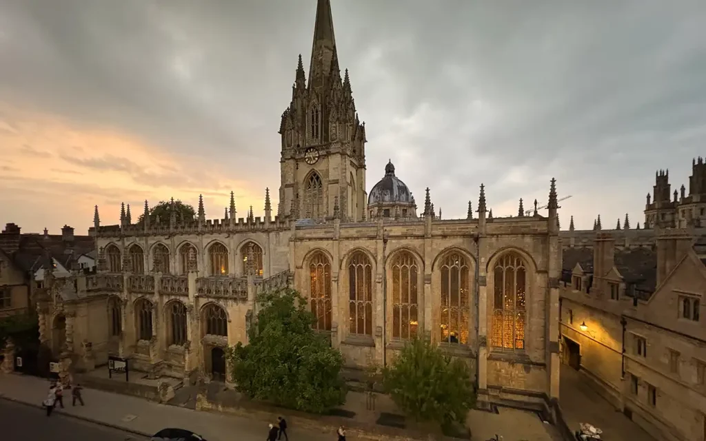 Exterior of the University Church of St Mary the Virgin in Oxford at sunset, opposite the Old Bank Hotel